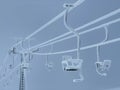 CLOSE UP: Chairlift at closed ski resort weathers the extreme winter conditions Royalty Free Stock Photo