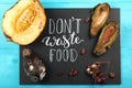 Close up of a chalkboard with Don`t waste food lettering and rotten fruits. Selective focus Royalty Free Stock Photo