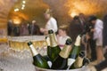 Close-Up on champagne bottle's in a bucket with ice, , champagne flutes in background. Royalty Free Stock Photo