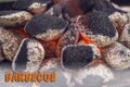 Close up of charcoal briquettes ready for barbecue grill, background with letters Royalty Free Stock Photo