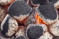 Close up of charcoal briquettes ready for barbecue grill, burning charcoal grill