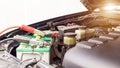 Close up Charging car battery with electricity through jumper cables Royalty Free Stock Photo