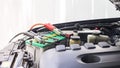 Close up Charging car battery with electricity through jumper cables Royalty Free Stock Photo