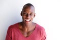 Close up charming african american man laughing by white wall