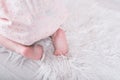 Close up of the charming bare baby feet on the floor.