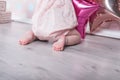 Close up of the charming bare baby feet on the floor.