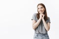 Close up of charming good-looking young student girl with dark hair and eyes in casual outfit smiling, looking aside Royalty Free Stock Photo