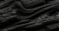 Close-up of charred wood, revealing detailed textures and deep cracks. The layered, wavy pattern Royalty Free Stock Photo