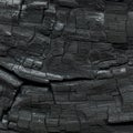 Close-up of a charred wood surface, displaying a pattern of deep Royalty Free Stock Photo