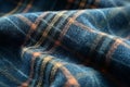 Close-up of checkered fabric highlighting blue, orange, and black threads, creating a textured and wavy pattern Royalty Free Stock Photo