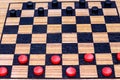 Close up checkers on checker board wood background