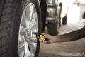 Close-up checking car tyre pressure with gauge Royalty Free Stock Photo