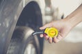 Close-up checking car tyre pressure with gauge Royalty Free Stock Photo