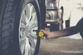 Close-up checking car tyre pressure with gauge Royalty Free Stock Photo