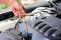 Close-up checking oil machine on a car.