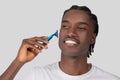 Man shaving with a blue razor on white background Royalty Free Stock Photo