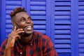 Close up cheerful afro american can man talking on cell phone and looking away Royalty Free Stock Photo