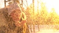 CLOSE UP: Cheerful female tourist blows fresh snow from her hand at sunrise. Royalty Free Stock Photo