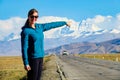 CLOSE UP: Cheerful female tourist points towards the peak of Mount Everest. Royalty Free Stock Photo