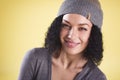 Close up of a cheerful trendy girl on yellow background.