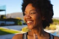 Close-up of cheerful young african american afro woman looking away while exercising in backyard Royalty Free Stock Photo