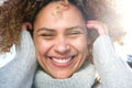 Close up cheerful young african american woman laughing with hands in hair Royalty Free Stock Photo