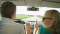 CLOSE UP: Cheerful young couple dancing during their drive through countryside Royalty Free Stock Photo