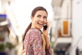 Close up cheerful young woman talking on mobile phone and laughing outside Royalty Free Stock Photo