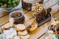 Close-up cheese bar of several kinds of cheese, snacks, honey, nuts decorated on wooden table at the wedding party