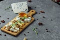 Close-up of a cheese plate. 4 types of cheese, soft white brie cheese, camembert, semi-soft briques, blue, roquefort, hard cheese Royalty Free Stock Photo