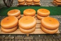 Close-up of cheeses stacks for sale at the Market Square fair in Gouda.