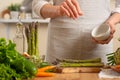 Close-up, chef cleans asparagus, with vegetables on a light background. A concept of losing healthy and healthy food, detox, dmet