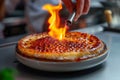 AI generated a close-up of a chef flambeing a dessert called Crme brle with a kitchen lighter Royalty Free Stock Photo