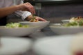 Close-up of chef garnishing meal on counter Royalty Free Stock Photo