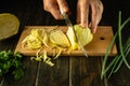 Close-up of a chef hands cutting fresh cabbage with a knife on a cutting board for preparing a vegetarian dish. Peasant food Royalty Free Stock Photo