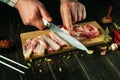 Close-up of a chef hands with a knife for cutting lard on a cutting board. National Ukrainian food for a snack. Lard is tasty only