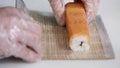 Close-up of chef hands preparing japanese food making sushi at restaurant. Young cook serving traditional modern japan Royalty Free Stock Photo