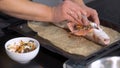 Close-up of chef preparing stuffed fish. Art. Professional chef prepares signature fish with vegetables. Dish of stuffed Royalty Free Stock Photo