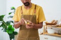 Close-up chef\'s hand-making breakfast, male chef wearing apron and both hands holding vegetable peeler, which has peel, Royalty Free Stock Photo