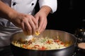 close-up of chef& x27;s hands mixing and stirring ingredients for delicious dish