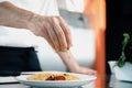Close-up of a chef sprinkling French omelet with finely chopped herbs in a professional kitchen Royalty Free Stock Photo
