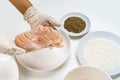 Close Up Chef's Hands Gloves with Raw Chicken Breast Fillets for Cooking with Flour, Eggs, Herbs and Peppers on White Table Royalty Free Stock Photo