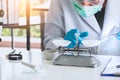 Close up, chemist or scientist researcher using mechanical scale for gathering and measuring specimen in experiment at laboratory