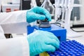 Close up of a chemist shaking samples using a vortex mixer before HPLC analysis