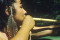 Close-up of Cherokee using a blow gun, Tsalagi Village, Cherokee Nation, OK