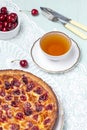 Close up of cherry pie on a plate with a bowl of cherries Royalty Free Stock Photo