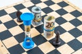 Close-up of chess board with black knight and black bishop placed near rolled euro bank notes and American dollar bills Royalty Free Stock Photo