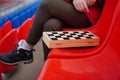 Close up of chess on stadium bleacher. Body part of unrecognizable woman playing in board game in cold weather
