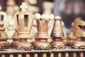 Close up of chessboard with wooden pieces on table in sunlight. Chess game, close up image with selective focus Royalty Free Stock Photo