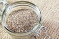 Close up of Chia seeds in a jar on linen background. Royalty Free Stock Photo